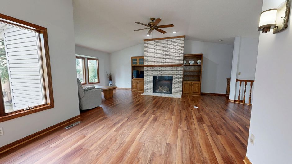 Renovated ranch house living room with warm layered lighting and low ceiling